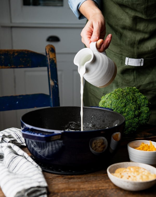 Pouring milk into a Dutch oven