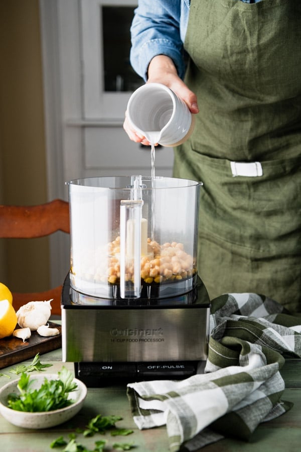 Pouring water into a food processor