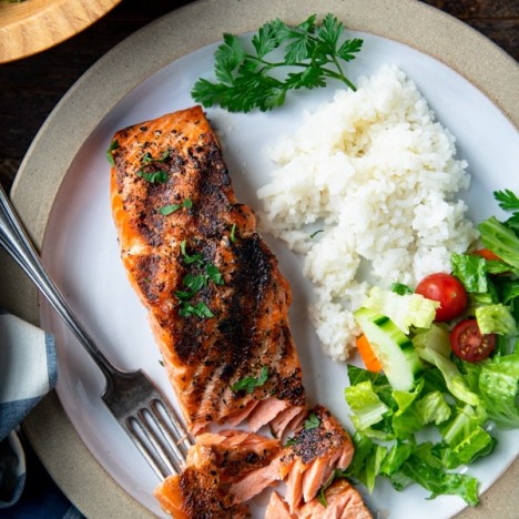 Overhead shot of the perfect grilled salmon recipe on a white plate