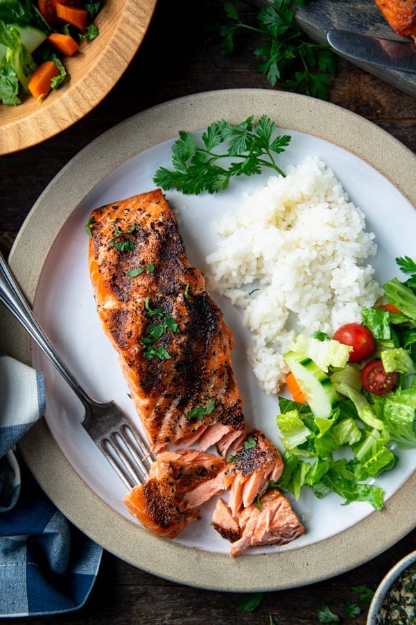 Overhead shot of the perfect grilled salmon recipe on a white plate