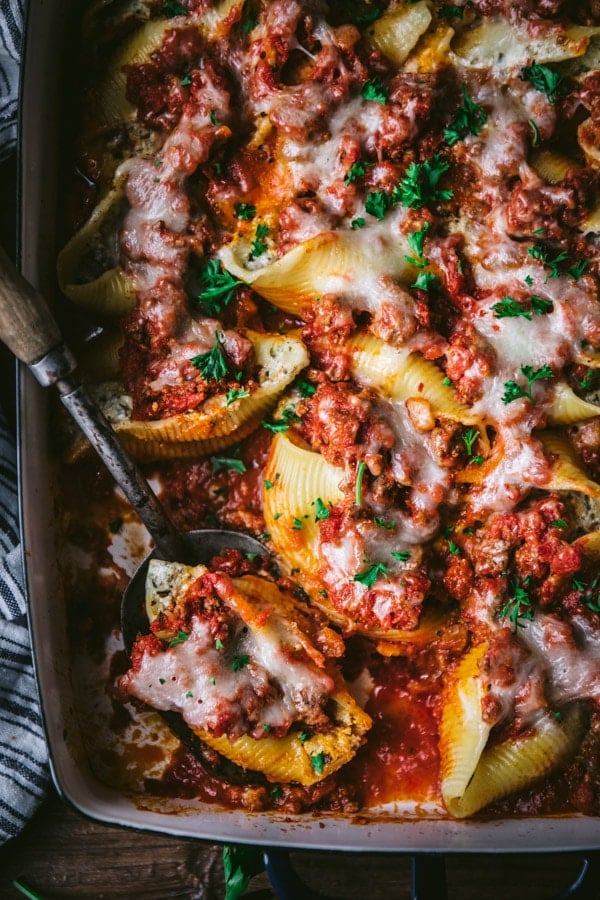 Close overhead shot of a spoon with beef stuffed shells