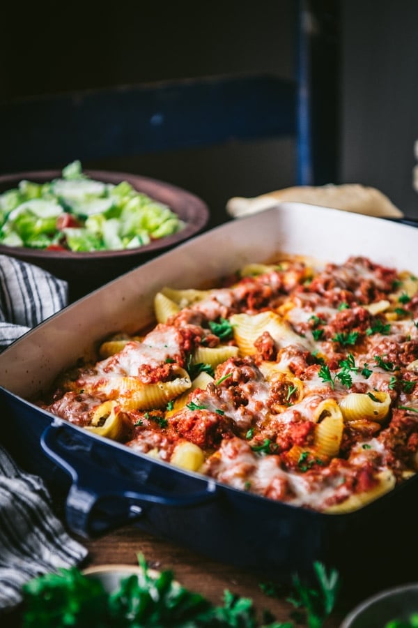 Side shot of stuffed shells ricotta in a pan on a dinner table