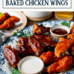 Side shot of a tray of baked bbq chicken wings with text title box at top