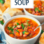 Close up side shot of a bowl of ham and bean soup with text title overlay