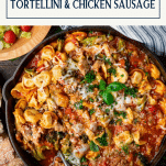 Chicken sausage and tortellini in a skillet with text title box at top