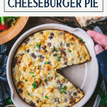 Overhead image of hands holding a pan of Bisquick cheeseburger pie with text title box at top