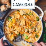 Overhead shot of hands serving chicken broccoli and rice casserole with text title overlay