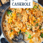 Close overhead shot of a pan of chicken broccoli and rice casserole with text title box at top