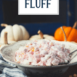 Side shot of a bowl of cranberry fluff with text title overlay