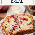 Plate of sliced cranberry orange bread with text title box at top
