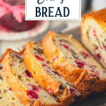 Close up shot of a loaf of cranberry bread with text title overlay