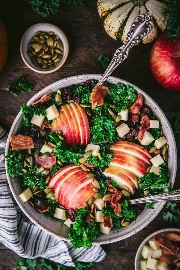 Overhead image of a beautiful fall kale salad with sliced apples