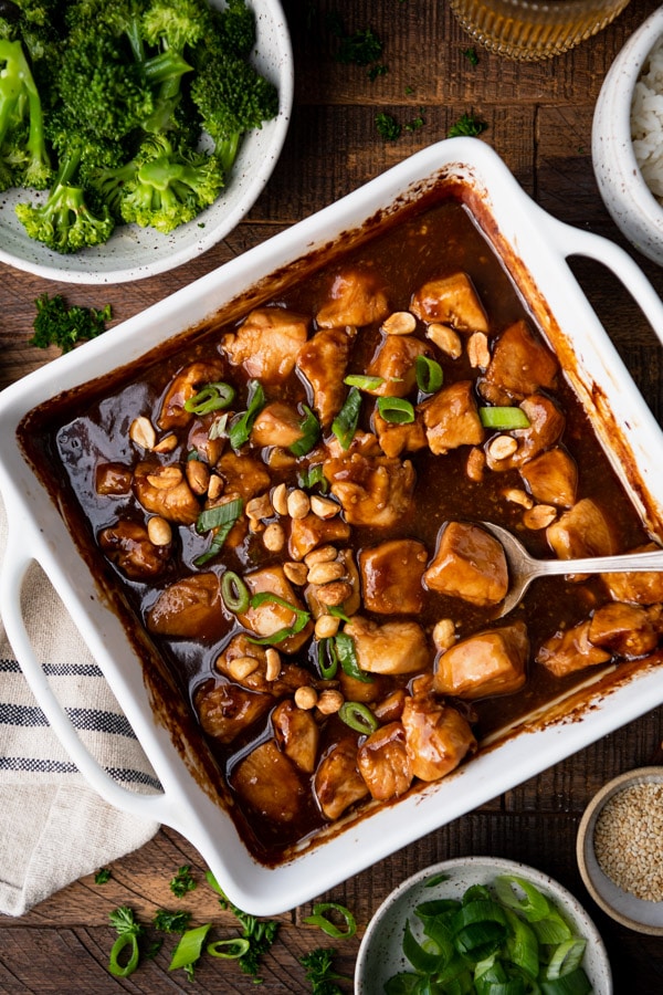 General Tso's chicken in a baking dish on a wooden table.