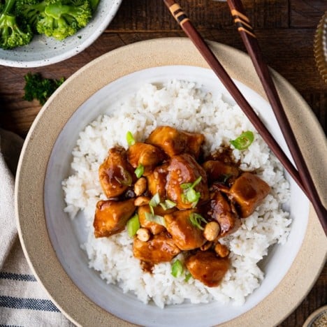 Close overhead shot of healthy general tso chicken recipe served in a bowl with rice and broccoli
