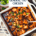 Overhead shot of general tso chicken in a white dish with text title overlay