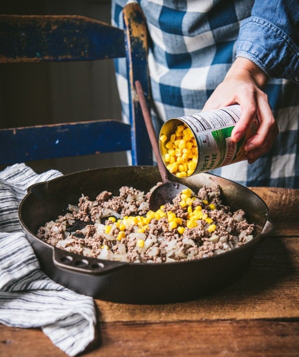 Adding canned corn to a skillet