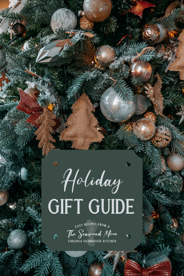 Christmas tree in the background with holiday gift guide text overlay