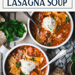 Overhead shot of two bowls of lasagna soup with text title box at top