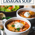 Side shot of lasagna soup in a bowl with text title box at top