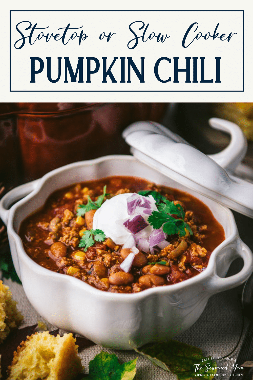 Close up side shot of a white bowl of pumpkin chili recipe with text title box at top