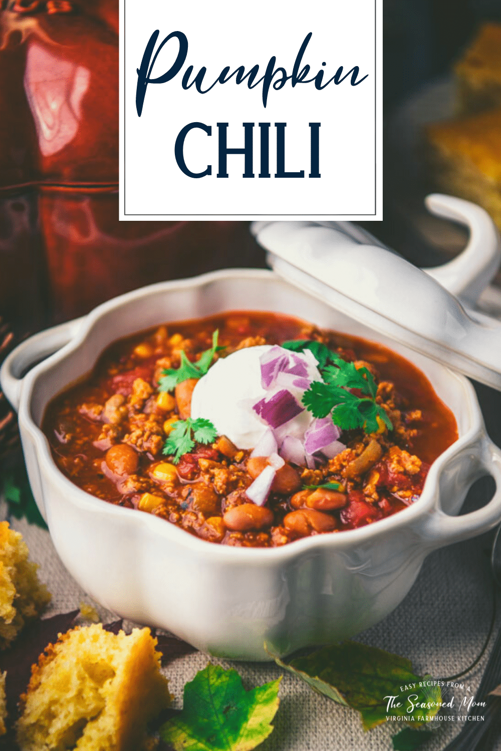Close up side shot of a bowl of pumpkin chili with text title overlay