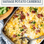 Diagonal overhead shot of a pan of sausage hash brown casserole with text title box at top