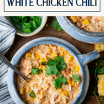 Close overhead image of a bowl of slow cooker cream cheese chicken chili with text title box at top