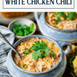 Side shot of a bowl of the best white chicken chili recipe with text title box at top