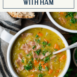 Overhead image of a spoon in a bowl of split pea soup with ham and text title box at top