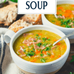 Side shot of a spoon in a bowl of split pea soup with text title overlay