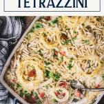 Spoon in a pan of turkey tetrazzini with text title box at top
