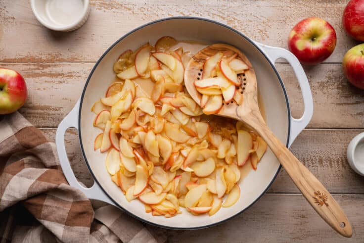 Sauteing apples in a skillet.