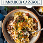 Close overhead image of a bowl of hamburger casserole with text title box at top.