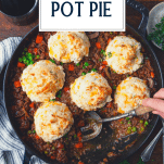 Overhead image of a skillet full of ground beef pot pie with text title overlay.
