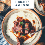 Overhead image of a fork in a bowl of braised beef with mashed potatoes and a text title overlay.