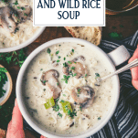 Overhead shot of hands eating a bowl of chicken and wild rice soup with text title overlay