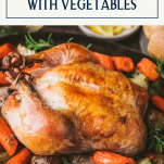 Close up shot of roast chicken in a pan with vegetables and text title box at top.