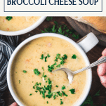 Overhead image of broccoli and cheese soup recipe on a dinner table with text title box at top.