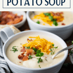 Side shot of loaded baked potato soup with text title box at top