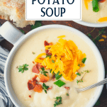 Close overhead shot of a bowl of crockpot potato soup with text title overlay.