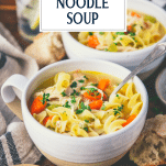 Side shot of homemade chicken noodle soup with text title overlay