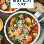 Spoon in a bowl of olive garden minestrone soup with text title overlay