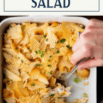 Hands serving hot chicken salad casserole from a dish with text title box at top.