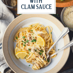 Overhead image of a bowl of linguine with white clam sauce and text title overlay.