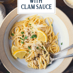 Close overhead shot of a bowl of linguine with clam sauce and text title overlay.