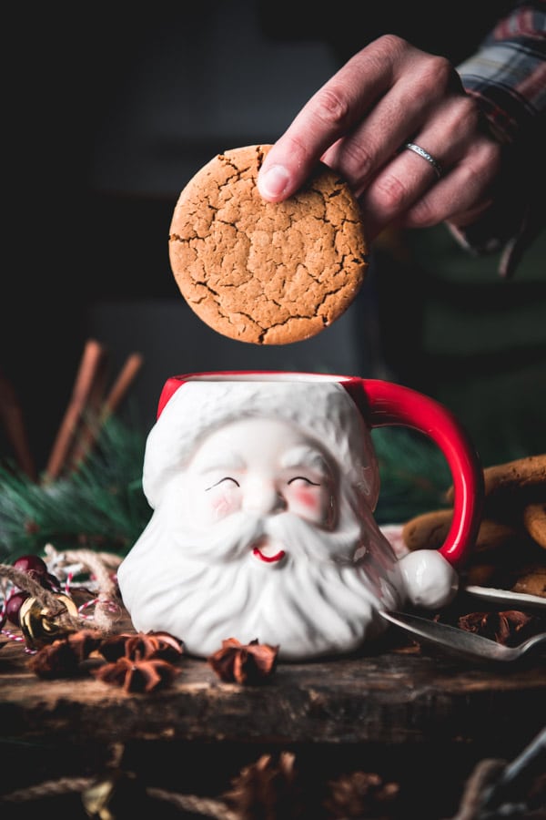 Side shot of soft gingerbread cookie dipped in a mug.