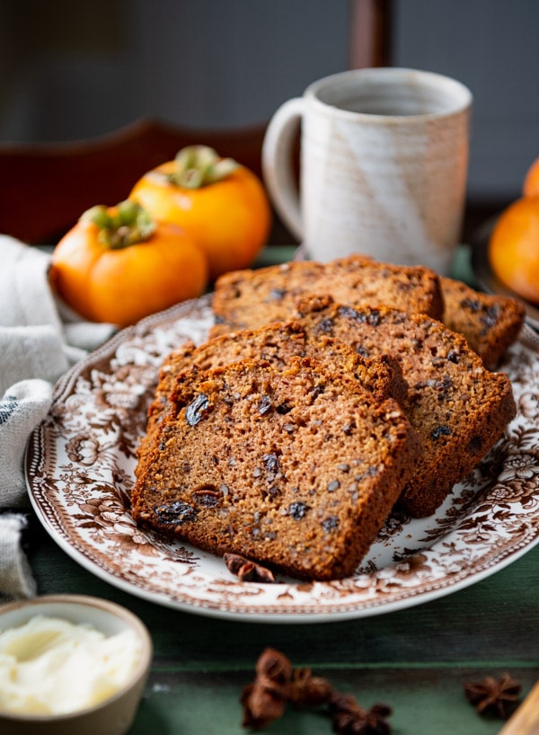 Side shot of a tray of sliced james beard persimmon bread