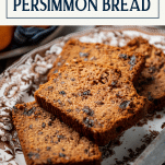 Side shot of a tray of persimmon bread with text title box at top