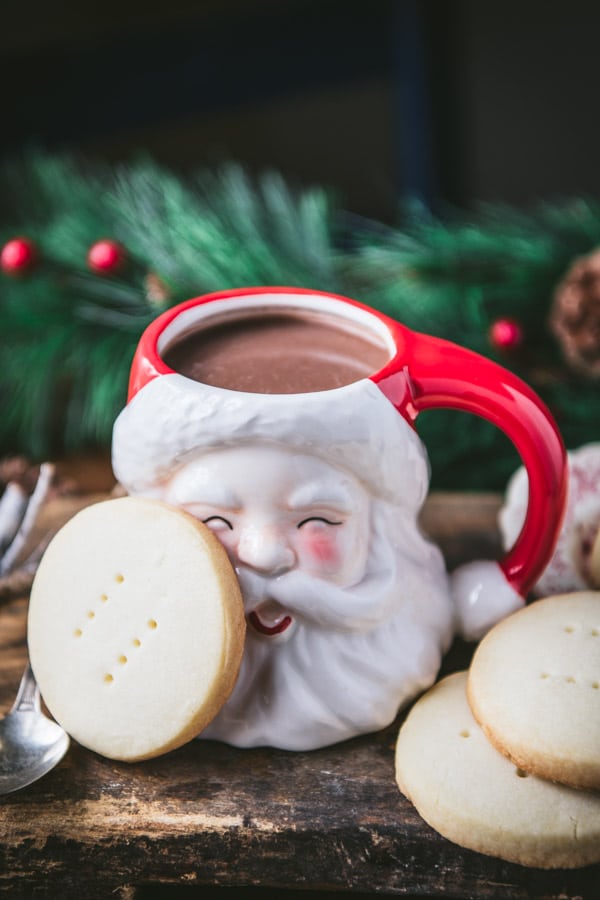 Christmas shortbread cookies next to a Santa mug.