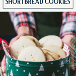 Hands gifting a tin of shortbread cookies with text title box at top.